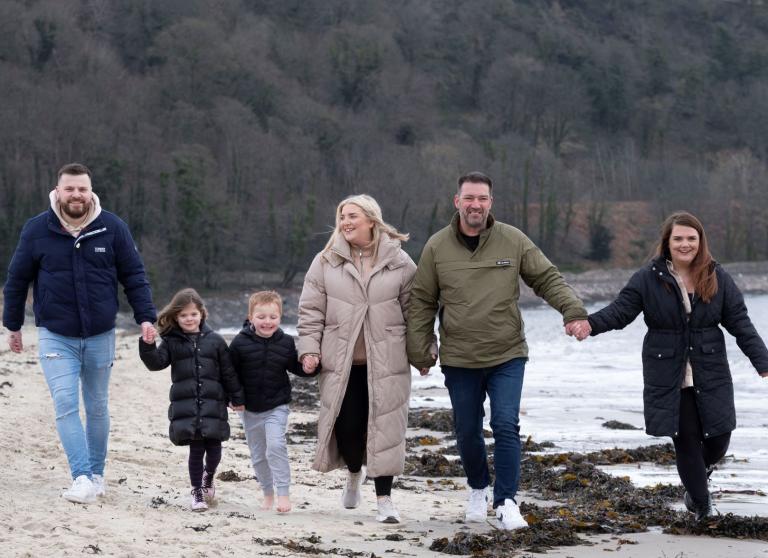 family walking on a beach