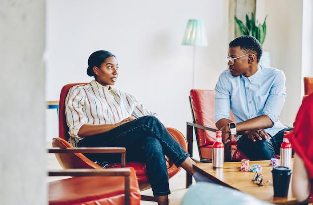 image of two people talking