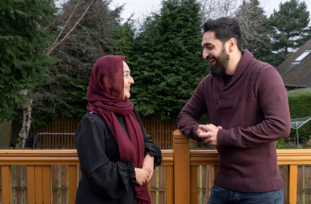 Living donor and his recipient sister smiling at each other